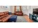 Cozy living room with hardwood floors, leather furniture, and ample natural light at 2564 S Acoma St, Denver, CO 80223