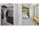 Well-organized walk-in closet leads to the bedroom with accent wall and seating at 18173 E Saskatoon Pl, Parker, CO 80134