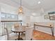 Cozy dining room features a round table and decorative hanging light fixture near an open railing at 18173 E Saskatoon Pl, Parker, CO 80134
