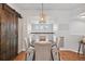 Cozy dining area featuring a round table, comfortable seating, and a modern chandelier at 18173 E Saskatoon Pl, Parker, CO 80134