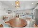 Open-concept dining room and kitchen area with modern lighting and stainless steel appliances at 18173 E Saskatoon Pl, Parker, CO 80134