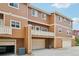 Townhome exterior showing attached garages, balconies, and wood siding at 18173 E Saskatoon Pl, Parker, CO 80134