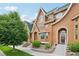 Inviting townhome exterior showcases unique architectural features, complemented by well-maintained landscaping at 18173 E Saskatoon Pl, Parker, CO 80134