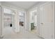 Hallway leading to the bedroom and bathroom with white doors and neutral carpet at 18173 E Saskatoon Pl, Parker, CO 80134