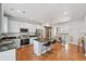 Well-lit kitchen featuring a center island with bar seating, stainless appliances, and adjacent dining space at 18173 E Saskatoon Pl, Parker, CO 80134