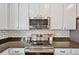 Modern kitchen features stainless steel appliances, granite counters and a classic subway tile backsplash at 18173 E Saskatoon Pl, Parker, CO 80134