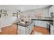 Spacious kitchen with an island, white cabinets, granite countertops, and an open layout at 18173 E Saskatoon Pl, Parker, CO 80134