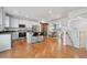 Open concept kitchen with modern appliances, an island with barstool seating, and hardwood floors at 18173 E Saskatoon Pl, Parker, CO 80134