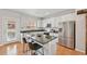 Bright kitchen with white cabinetry, stainless steel appliances, granite countertop island and access to the outside at 18173 E Saskatoon Pl, Parker, CO 80134