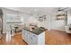 Open-concept space offers a spacious island, modern kitchen appliances, dining, and living area at 18173 E Saskatoon Pl, Parker, CO 80134