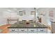 Bright and modern kitchen offering an island with bar stools and decorative accents on the wall at 18173 E Saskatoon Pl, Parker, CO 80134
