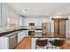 Modern kitchen with white cabinets, subway tile backsplash, stainless steel appliances and breakfast bar seating at 18173 E Saskatoon Pl, Parker, CO 80134