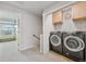 Laundry room with modern washer and dryer and cabinets at 18173 E Saskatoon Pl, Parker, CO 80134