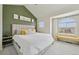 Bedroom boasts an accent wall, vaulted ceiling, large window, and comfortable seating at 18173 E Saskatoon Pl, Parker, CO 80134