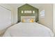 Cozy bedroom features a headboard with decorative pillows, an accent wall and natural light at 18173 E Saskatoon Pl, Parker, CO 80134