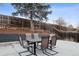 Backyard patio has a stone retaining wall with backyard and a wooden fence under a cloudy sky at 7488 S Lafayette E Cir, Centennial, CO 80122