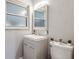 This bathroom features a modern vanity and toilet with a minimalist design with a window letting in natural light at 7488 S Lafayette E Cir, Centennial, CO 80122