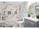 Stunning bathroom featuring marble tiling, a soaking tub, and a modern vanity with a round mirror at 7488 S Lafayette E Cir, Centennial, CO 80122