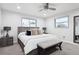 This cozy bedroom includes two windows, a ceiling fan, and a neutral color scheme to create a tranquil, serene atmosphere at 7488 S Lafayette E Cir, Centennial, CO 80122