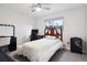 Bright bedroom with desk, ceiling fan, and modern dresser near a comfortable bed and an exterior view at 7488 S Lafayette E Cir, Centennial, CO 80122