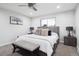 Neutral bedroom features a ceiling fan, light gray walls, and a comfortable bed with a wooden headboard at 7488 S Lafayette E Cir, Centennial, CO 80122