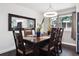 This dining room features a modern chandelier, dark wood table with seating for eight, and an adjacent large mirror at 7488 S Lafayette E Cir, Centennial, CO 80122