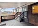 Covered front porch with decorative railing leading to a double door entrance and brick accents at 7488 S Lafayette E Cir, Centennial, CO 80122