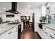 Open-concept kitchen featuring white cabinetry, marble countertops, and stainless steel appliances at 7488 S Lafayette E Cir, Centennial, CO 80122