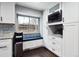 This kitchen features white cabinets, a built-in bench by the window, and stainless steel appliances for modern living at 7488 S Lafayette E Cir, Centennial, CO 80122