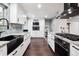 Modern kitchen featuring white cabinetry, marble countertops, and a stainless steel gas range at 7488 S Lafayette E Cir, Centennial, CO 80122