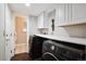 This laundry room features a washer and dryer with plenty of storage space and a door leading to another area at 7488 S Lafayette E Cir, Centennial, CO 80122