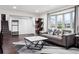 Inviting living room featuring a comfortable sofa, stylish coffee table, and plenty of natural light at 7488 S Lafayette E Cir, Centennial, CO 80122