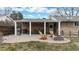 Outdoor backyard patio with stone pavers, built-in gas grill, and fire pit at 1823 S Carr St, Lakewood, CO 80232