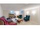 Spacious basement living area featuring cozy seating and a television at 1823 S Carr St, Lakewood, CO 80232