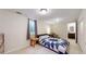 Finished basement bedroom with a dresser and lamp on a nightstand at 1823 S Carr St, Lakewood, CO 80232