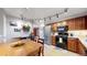Eat-in kitchen with stainless steel appliances, wooden cabinets, and track lighting at 1823 S Carr St, Lakewood, CO 80232