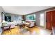 Bright living room with hardwood floors, neutral walls, and a large window that fills the space with natural light at 1823 S Carr St, Lakewood, CO 80232