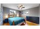 Inviting main bedroom with hardwood floors, a ceiling fan, and natural light from two windows at 1823 S Carr St, Lakewood, CO 80232