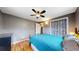 Spacious bedroom with hardwood floors, ceiling fan, and neutral walls complemented by stylish curtains at 1823 S Carr St, Lakewood, CO 80232