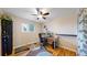 Functional office with hardwood floors, a modern desk setup, and a colorful accent rug to brighten the space at 1823 S Carr St, Lakewood, CO 80232