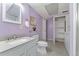 Basement bathroom features purple walls, vanity and shelving unit at 10836 W Evans Ave # 29, Lakewood, CO 80227
