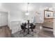 Inviting dining area with modern lighting and hardwood floors, open to living space at 10836 W Evans Ave # 29, Lakewood, CO 80227