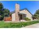Inviting home exterior showcasing a brick chimney, covered entry, and verdant lawn at 10836 W Evans Ave # 29, Lakewood, CO 80227