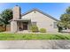Charming home exterior featuring a brick chimney, covered porch, and well-maintained landscaping at 10836 W Evans Ave # 29, Lakewood, CO 80227