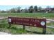 Cottonwood Park sign with lush green grass, trees, and blue sky background, near 10461 W. Evans Ave at 10836 W Evans Ave # 29, Lakewood, CO 80227