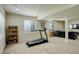 Finished basement featuring a treadmill, living space, and neutral carpet, perfect for exercise and entertainment at 2033 E 167Th Way, Thornton, CO 80602