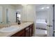 Bathroom featuring double sinks, granite countertop and view of the bedroom at 2033 E 167Th Way, Thornton, CO 80602