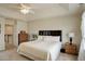 Well-lit bedroom with a bed, dresser, and view of the stairway landing at 2033 E 167Th Way, Thornton, CO 80602