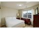 Bright bedroom featuring a comfortable bed, dresser, and natural light from a window with white curtains at 2033 E 167Th Way, Thornton, CO 80602