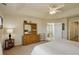 Bright bedroom features tray ceiling, large dresser, and en suite bathroom at 2033 E 167Th Way, Thornton, CO 80602